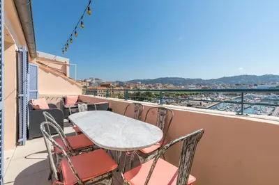 a table and chairs on a balcony with a view at Cozystay 1674 - Gorgeous sea view 3-bedroom duplex in Cannes