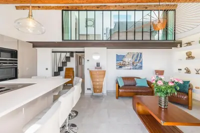 a kitchen and living room with a couch and a table at Cozystay 1674 - Gorgeous sea view 3-bedroom duplex in Cannes