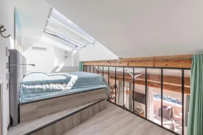 a room with a balcony with a bed on it at Cozystay 1674 - Gorgeous sea view 3-bedroom duplex in Cannes