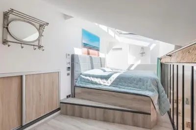a bedroom with a bed and a mirror at Cozystay 1674 - Gorgeous sea view 3-bedroom duplex in Cannes