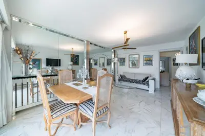 a dining room and living room with a table and chairs at Apartment for 4 people in the heart of Cannes in Cannes
