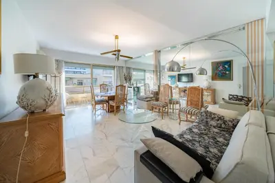 a living room with a couch and a dining room at Apartment for 4 people in the heart of Cannes in Cannes