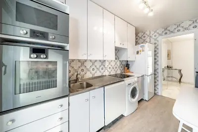 a kitchen with white cabinets and a sink and a dishwasher at Apartment for 4 people in the heart of Cannes in Cannes