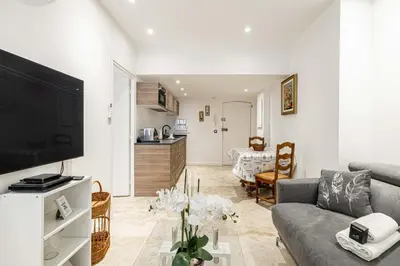 a living room with a couch and a tv at 84 MEY - Apartment for 4 people near Croisette and Palais in Cannes