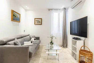 a living room with a couch and a tv at 84 MEY - Apartment for 4 people near Croisette and Palais in Cannes