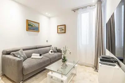 a living room with a couch and a glass table at 84 MEY - Apartment for 4 people near Croisette and Palais in Cannes