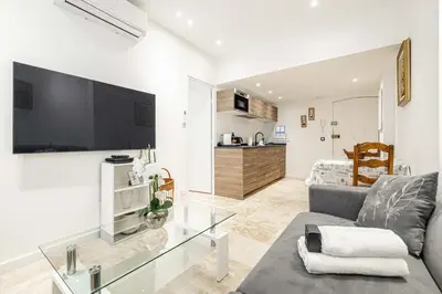 a living room with a couch and a glass table at 84 MEY - Apartment for 4 people near Croisette and Palais in Cannes