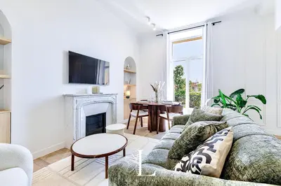 a living room with a couch and a fireplace at Les Lucioles 7- Luxury 2 - Bedroom Apartment in Cannes