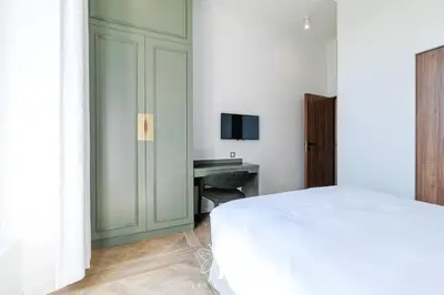 a bedroom with a white bed and a desk at Les Lucioles 7- Luxury 2 - Bedroom Apartment in Cannes
