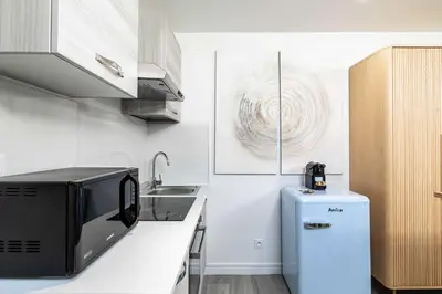 a kitchen with a microwave and a refrigerator at Renovated and Bright Studio 3P - Cannes in Cannes