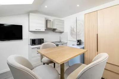 a kitchen with a table and chairs in a room at Renovated and Bright Studio 3P - Cannes in Cannes