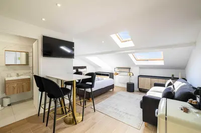 a bedroom with a bed and a table with chairs at Renovated and Bright Studio 4P - Cannes in Cannes