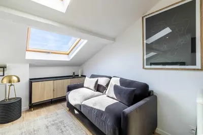 a living room with a couch and a window at Renovated and Bright Studio 4P - Cannes in Cannes
