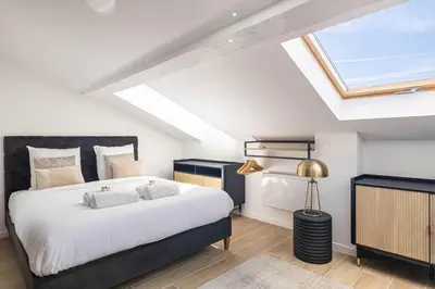 a bedroom with a large bed and a skylight at Renovated and Bright Studio 4P - Cannes in Cannes