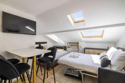 a room with a bed and a table and chairs at Renovated and Bright Studio 4P - Cannes in Cannes
