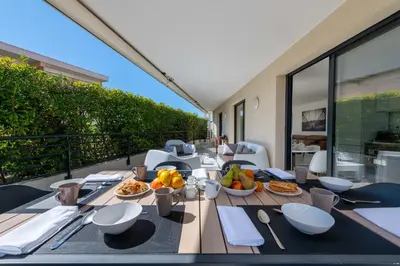 a table with food on top of a balcony at 3-Br Rooftop with Jacuzzi & Parking Cannes in Cannes