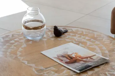a table with a bottle of water and a magazine at 3-Br Rooftop with Jacuzzi & Parking Cannes in Cannes
