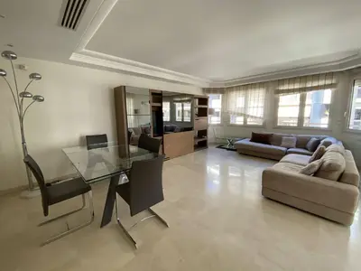 a living room with a glass table and a couch at Cannes Proche Croisette - Appartement 3 pièces in Cannes