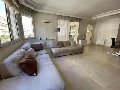 a large living room with a white couch and two couches at Cannes Proche Croisette - Appartement 3 pièces in Cannes