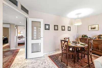 a dining room with a table and chairs and a living room at Appartement Cannes Hyper Centre in Cannes
