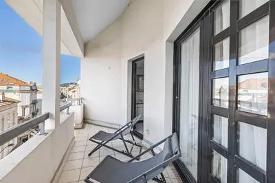a balcony with two chairs and a window at Appartement Cannes Hyper Centre in Cannes