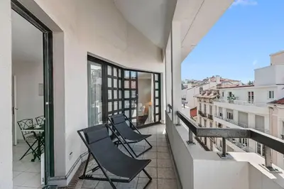 a balcony with chairs and a view of a city at Appartement Cannes Hyper Centre in Cannes