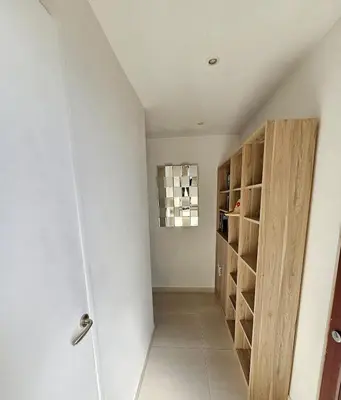a hallway with a door to a room with wine racks at Appartement 2 pièces, emplacement de rêve Martinez in Cannes