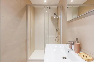 a bathroom with a shower and a white sink at Le Hub Studio central climatisé avec terrasse in Cannes