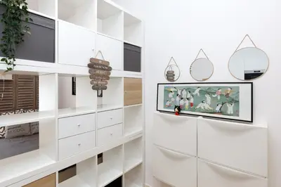 a living room with a tv on a wall at Le Hub Studio central climatisé avec terrasse in Cannes