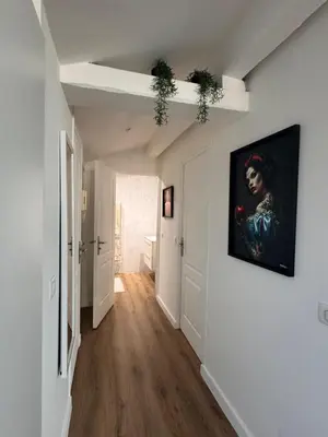 a hallway with a painting of a woman on a wall at Le Loft Cannes in Cannes