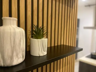 a white vase and a plant on a table at Apparemment cosy avec balcon plein centre de Cannes - Carla home in Cannes