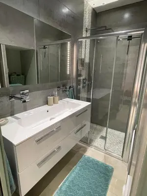 a bathroom with a white sink and a shower at Apparemment cosy avec balcon plein centre de Cannes - Carla home in Cannes