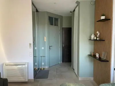 a hallway with a blue door in a room at Apparemment cosy avec balcon plein centre de Cannes - Carla home in Cannes