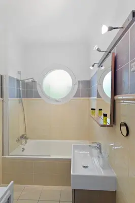 a bathroom with a sink and a bath tub at Le Tivoli - City Centre - Quiet - Spacious in Le Cannet