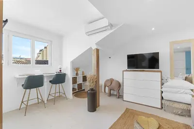 a white living room with a bed and a desk at Studio V - à 2 min du Palais - Hypercentre - Calme in Cannes
