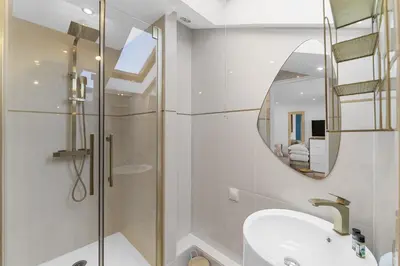 a bathroom with a shower and a sink and a mirror at Studio V - à 2 min du Palais - Hypercentre - Calme in Cannes