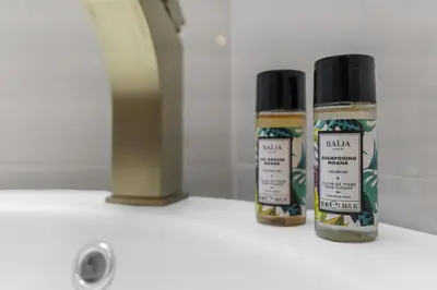 two bottles of paint sitting on a bathroom counter at Studio V - à 2 min du Palais - Hypercentre - Calme in Cannes