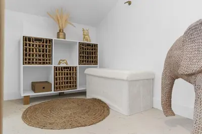 a white room with a chair and a stool at Studio V - à 2 min du Palais - Hypercentre - Calme in Cannes