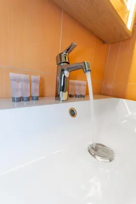 a sink with water running from a faucet at Le Farniente - Peaceful - Parking - AC - Balcony in Le Cannet