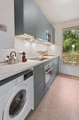 a kitchen with a washing machine and a sink at Le Farniente - Peaceful - Parking - AC - Balcony in Le Cannet