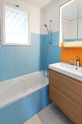 a bathroom with a tub and a sink and a mirror at Le Farniente - Peaceful - Parking - AC - Balcony in Le Cannet