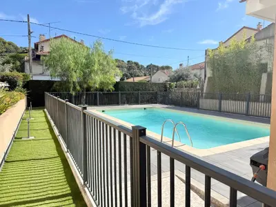 a swimming pool on a balcony with a fence at T2 - piscine - garage privé - 5 min de Cannes in Le Cannet
