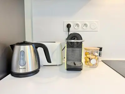 a kitchen counter with a coffee maker and a toaster at T2 - piscine - garage privé - 5 min de Cannes in Le Cannet