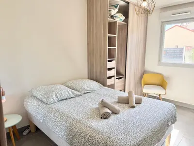 a bedroom with a bed with two teddy bears on it at T2 - piscine - garage privé - 5 min de Cannes in Le Cannet