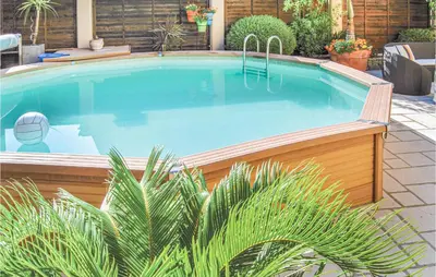 a large swimming pool in a yard with plants at 2 Bedroom Awesome Apartment In Cannes in Cannes
