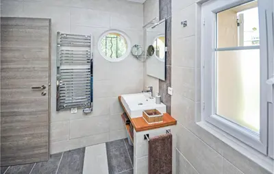a bathroom with a sink and a mirror at 2 Bedroom Awesome Apartment In Cannes in Cannes