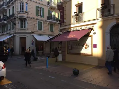a store with a purple awning on a city street at Gray d' Albion Apartment in Cannes