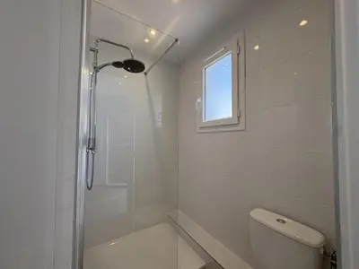 a white bathroom with a shower and a toilet at 285G Studio 5mn Palais in Cannes
