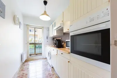 a kitchen with a large television on the wall at Apartment Seaside in Cannes