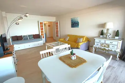 a kitchen and living room with a table and a couch at Apartment Seaside in Cannes